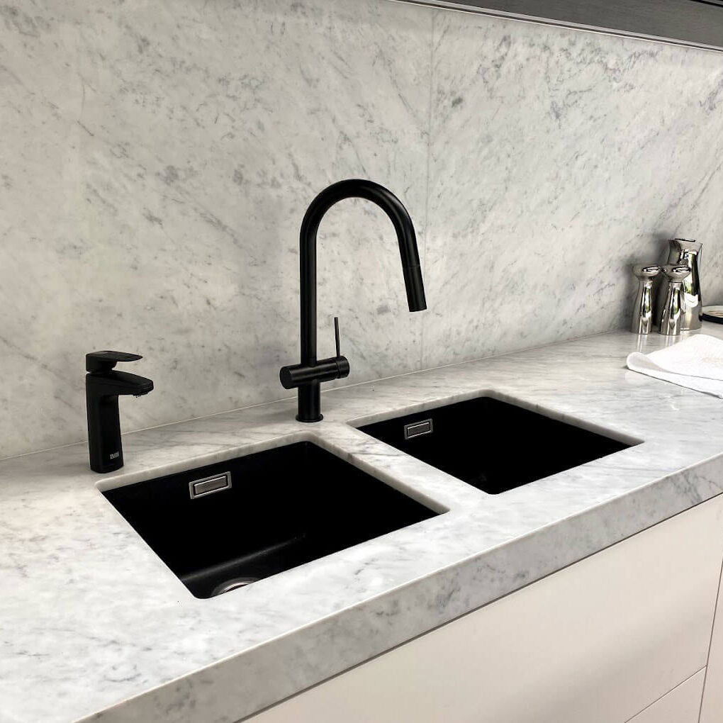 Kitchen bench with 2 black sinks and a tap